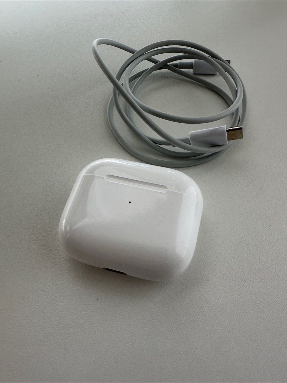 Apple AirPods 4 with charging case and cable